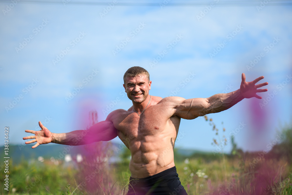 Huge muscles man happy, breath fresh air, feel freedom