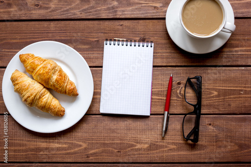 Business breakfast with coffee and croussant top view photo