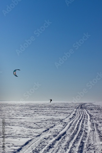 Traces of a snowmobile and kitesurfer is on the snow on Ob reservoir, Novosibirsk. The photo was taken March 7, 2016
