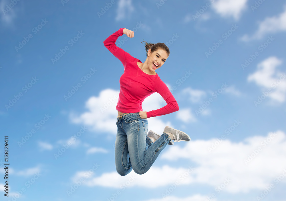 smiling young woman jumping in air smiling young woman jumping in air