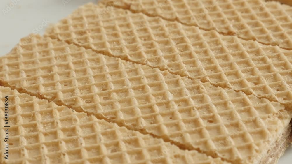 Sweet thin waffle biscuit pattern close-up 4K 21560p 30fps UltraHD slow pan footage - Israeli type wafer pieces on plate panning Sweet thin waffle biscuit pattern close-up 4K 21560p 30fps UltraHD slow pan footage - Israeli type wafer pieces on plate panning