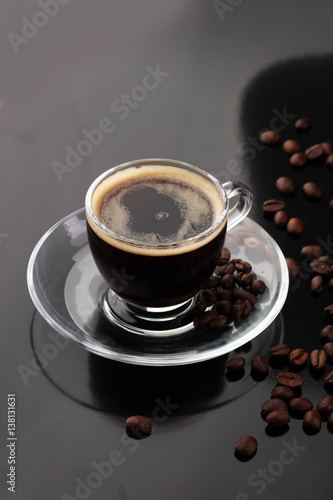 Coffee cup and coffee beans on table