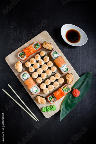 Sushi rolls set served on black background. Flat lay. Top view
