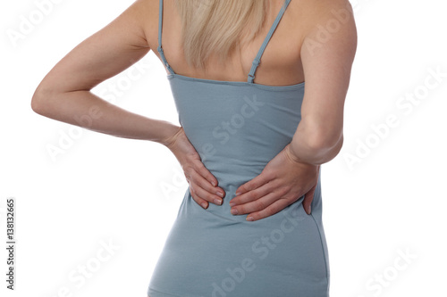 Back Pain. Athletic fitness woman rubbing the muscles of her lower back. Sports exercising injury.