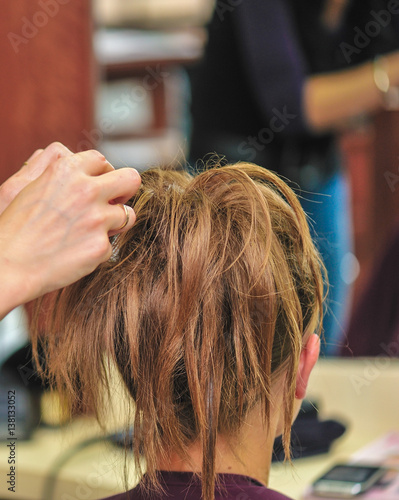 Hairdresser applying hair gel