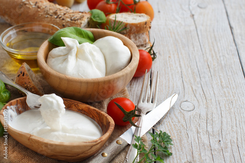 Italian cheese burrata with bread, vegetables and herbs