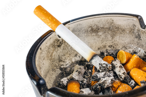 Close up of cigarette in ashtray on white background