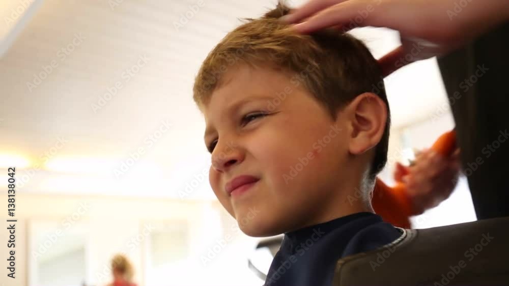 Little boy having a haircut at the barber shop. 8 year old boy having his  hair cut Stock Video | Adobe Stock