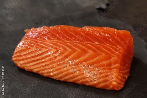 Fresh salmon fillet on slate background, selective focus