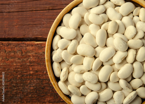 White kidney bean in bowl on wooden background. Horizontal, toned