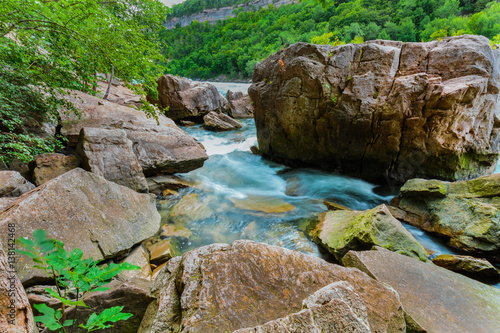 Beautiful amazing gorgeous natural landscape view of Niagara Falls escarpment rushing river with big rocks and stones background 