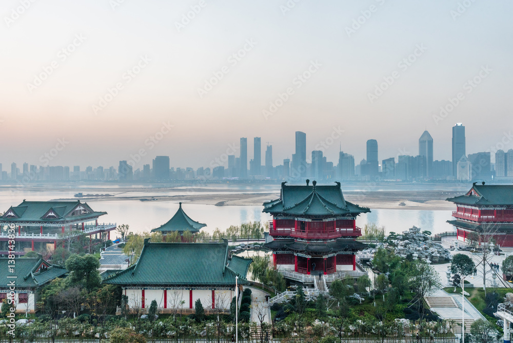 Obraz premium buildings standing by riverside under dramatic sky in Nanchang,China.