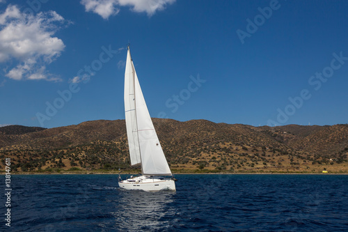 Ship yachts with white sails in the open Sea. Luxury sailing boats.