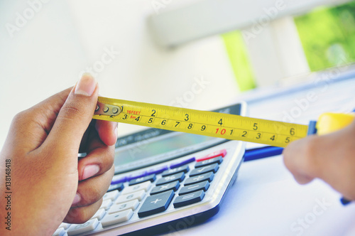 Wallpaper Mural A young Asian construction hands hold Ten centimeter  on the tape measure Torontodigital.ca