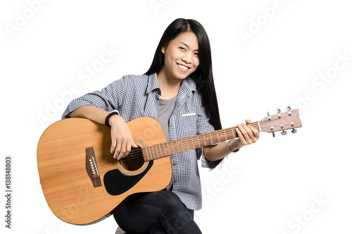Portrait of a young business woman smiling with guitar. Isolated on white background with copy space