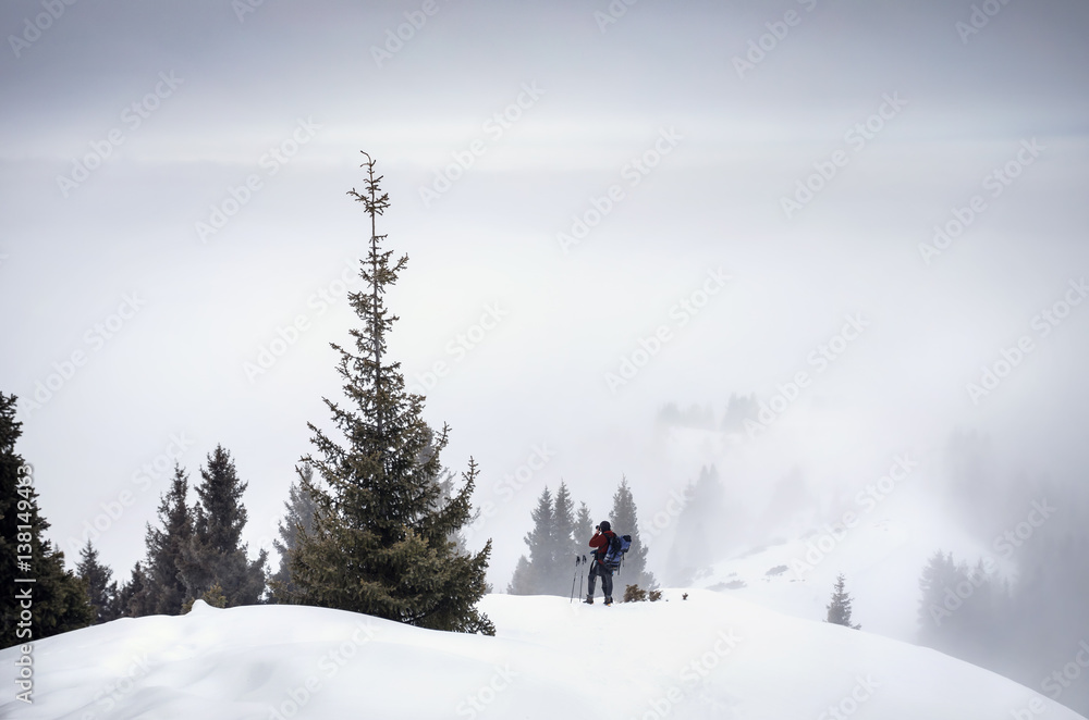 Photographer in the snowy mountains