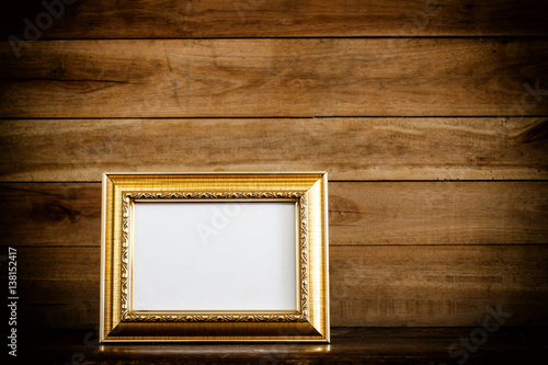 photo frame on grunge wooden background © PThira89