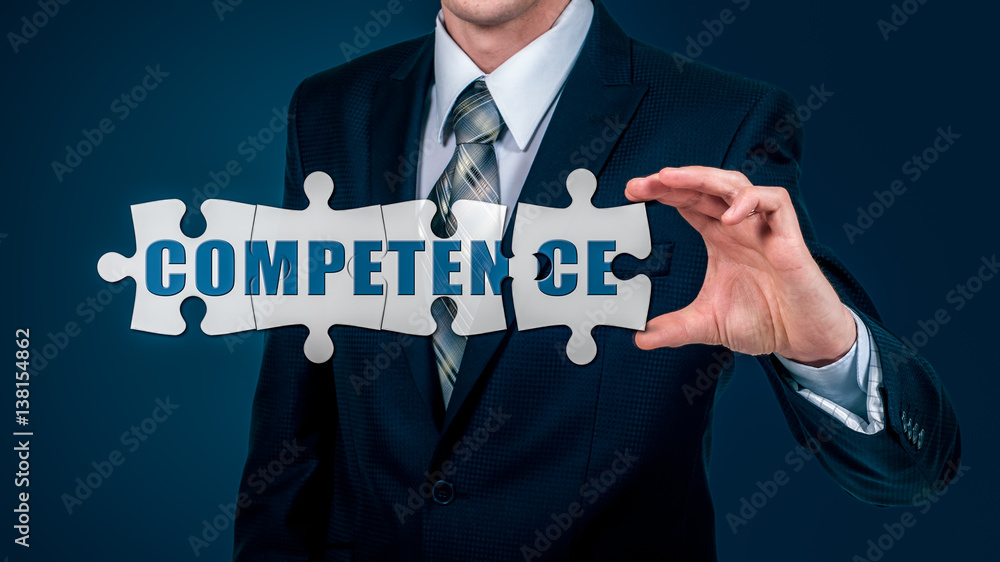 The businessman puts on the virtual puzzles word competence. The business concept. The businessman puts on the virtual puzzles word competence. The business concept.