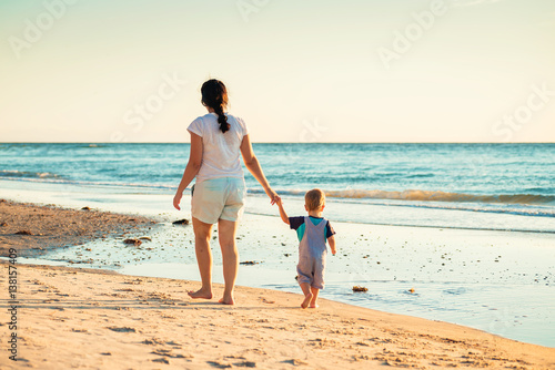 Mother and son walking on beach