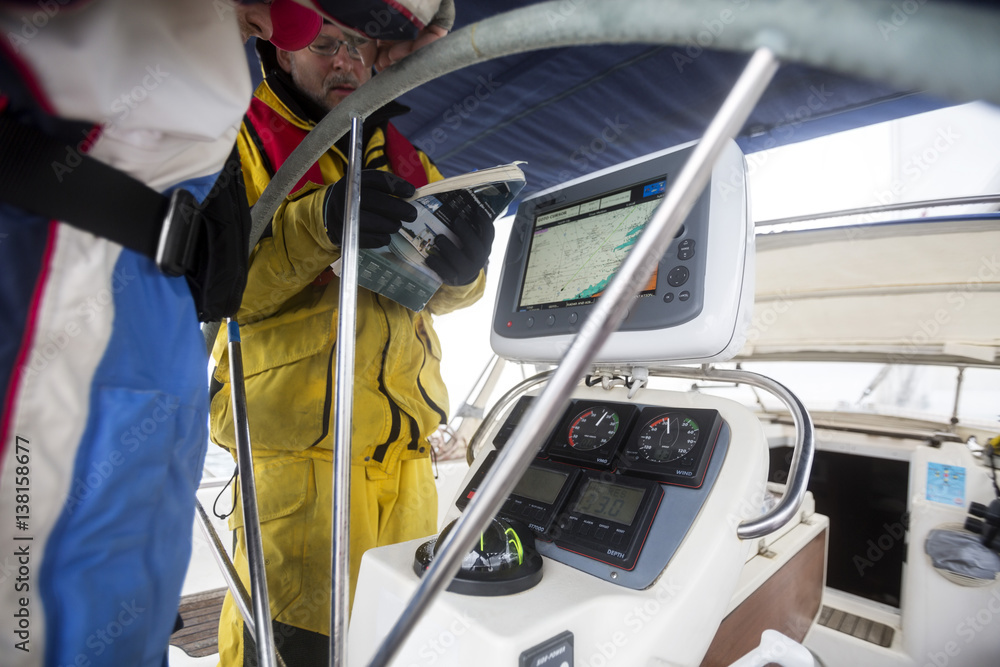 Fototapeta premium Men With Map Having Discussion On Sail Boat