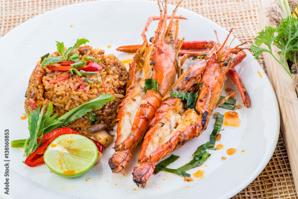 Asian fried rice nasi goreng with chicken, prawns, egg and vegetables, Thai cuisine Asian fried rice nasi goreng with chicken, prawns, egg and vegetables, Thai cuisine