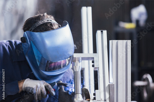 Unrecognizable worker welding with metal detail