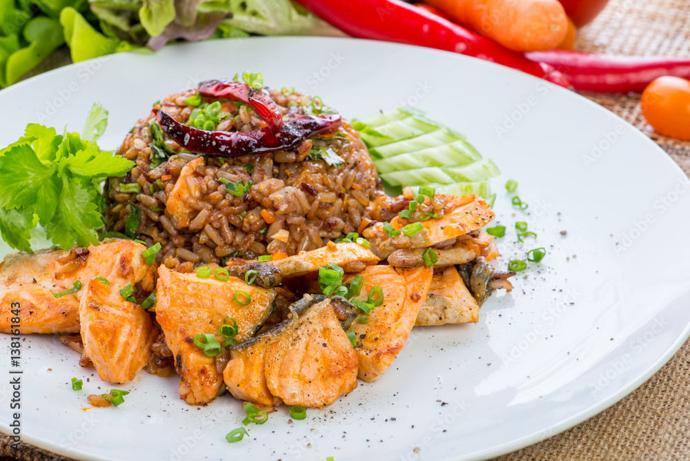 chinese cuisine, salt salmon fish and egg fried rice and vegetables with ingredients on rustic background. chinese cuisine, salt salmon fish and egg fried rice and vegetables with ingredients on rustic background.