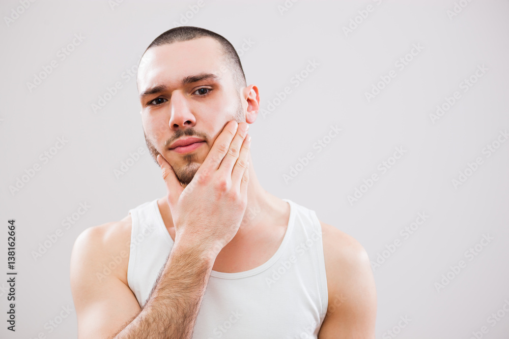 Young man is going to shave his beard. Young man is going to shave his beard.