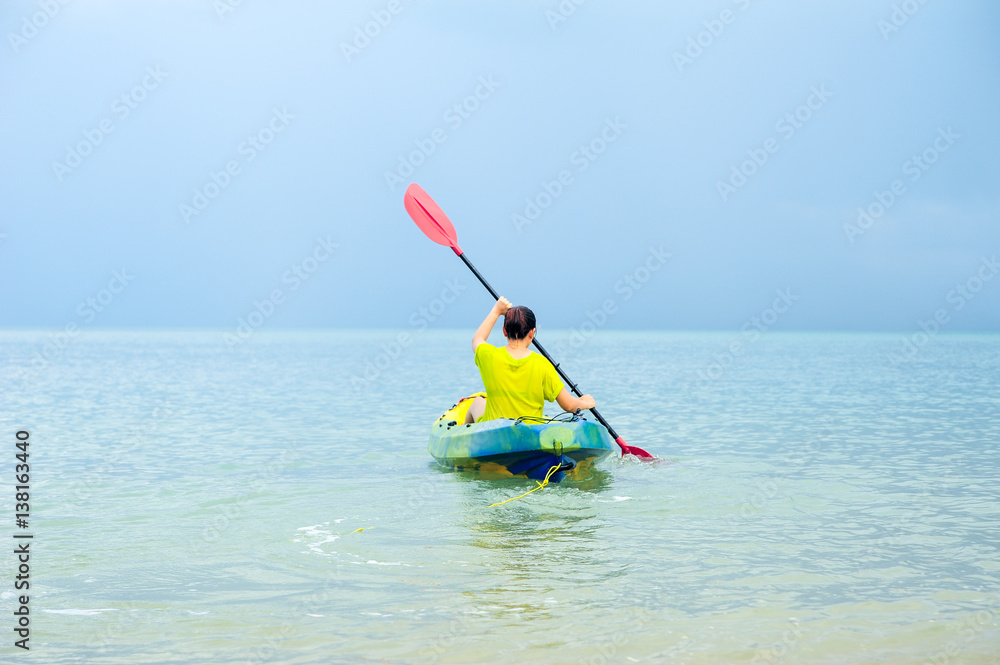 Woman Kayaking in the Ocean on Vacation in Thailand