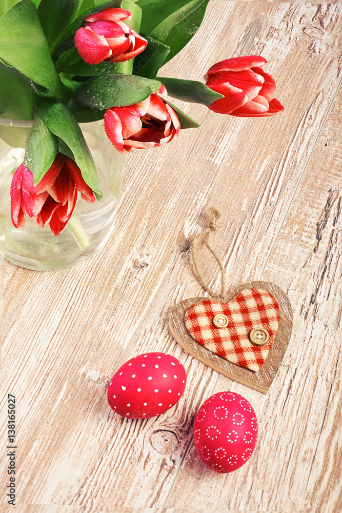Pink tulips and couple of Easter eggs on wooden table Pink tulips and couple of Easter eggs on wooden table