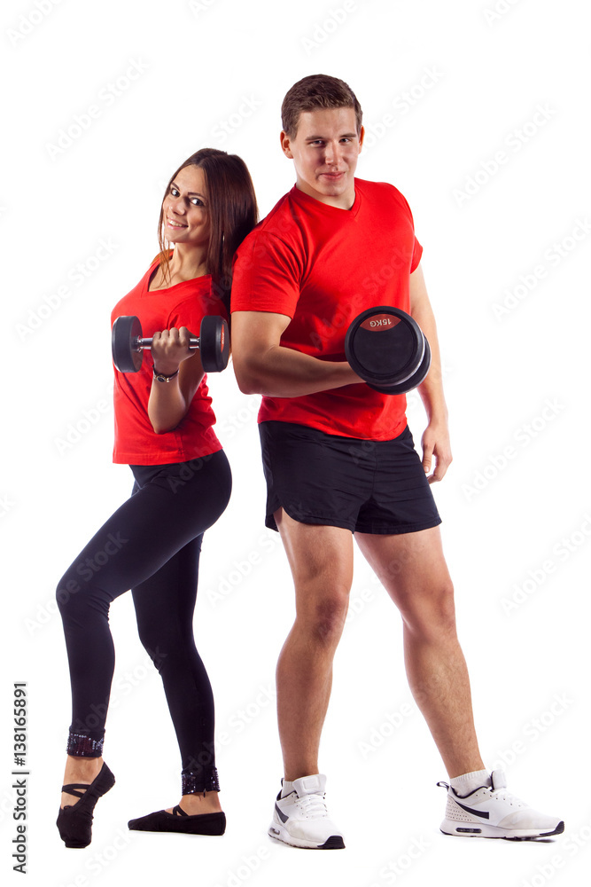 Muscular bodybuilder guy with woman doing exercises with dumbbells over white background