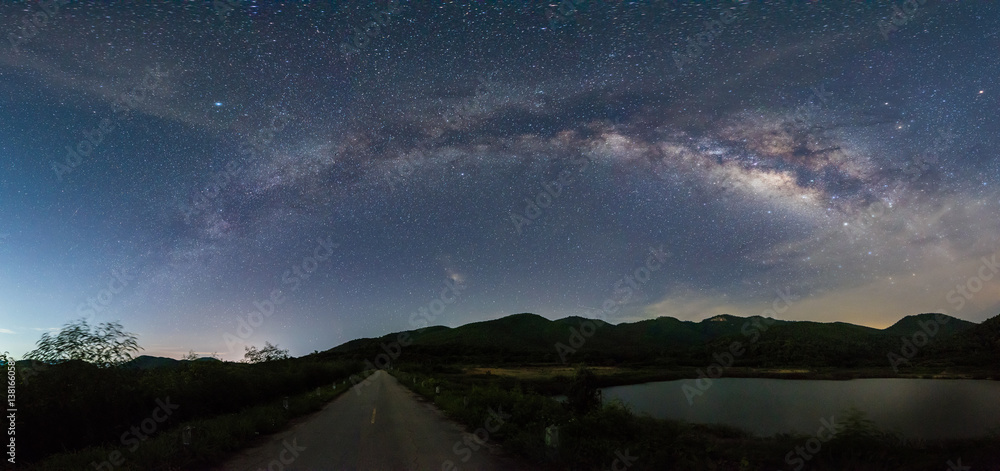 Fototapeta premium Panorama of Milky way over reservoir with mountain night