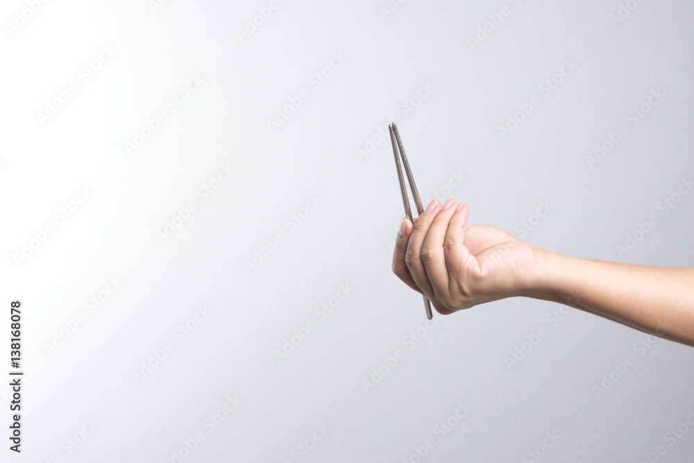 Hand holding stainless chop stick Hand holding stainless chop stick