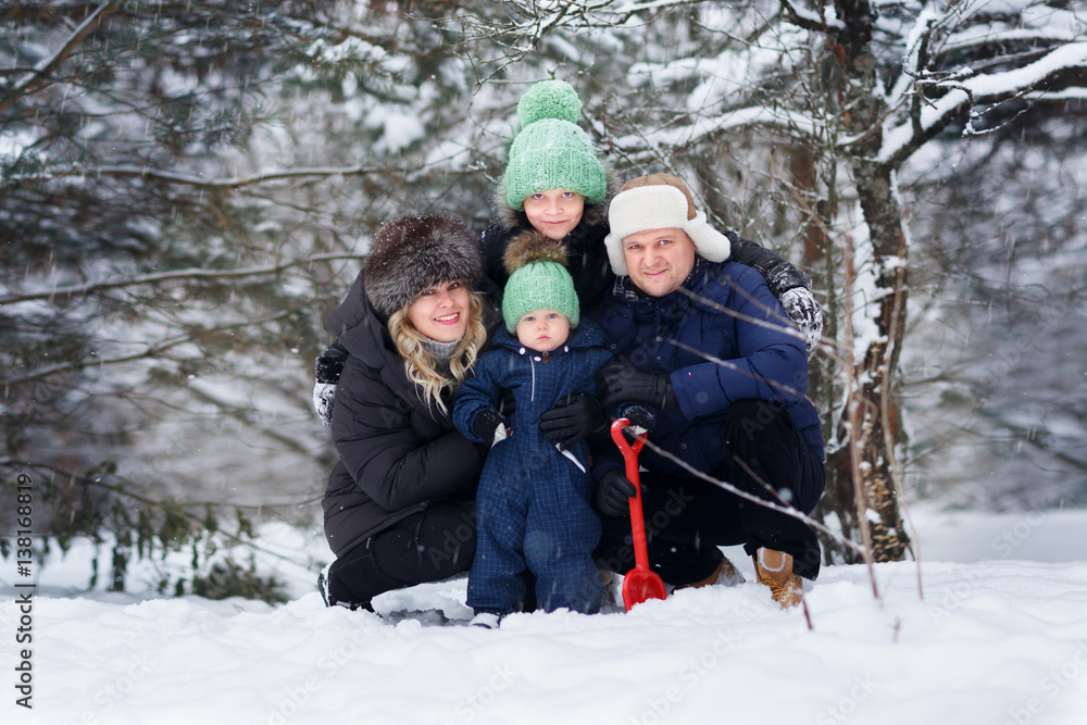 Obraz premium Parents with two sons outdoor. Winter. .