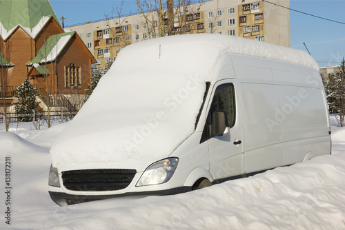 Car in the snow on the street the northern city in Russia