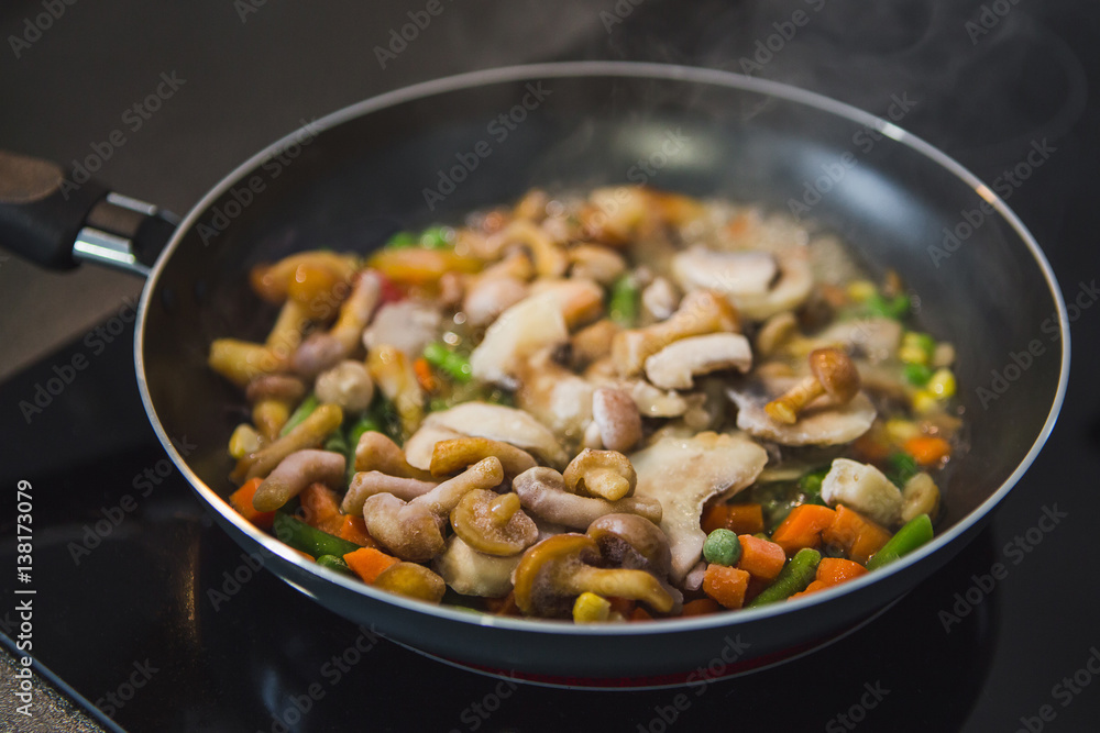 vegetables are boiling stove: carrots, mushrooms, peas, corn, tomato. vegetables are boiling stove: carrots, mushrooms, peas, corn, tomato.