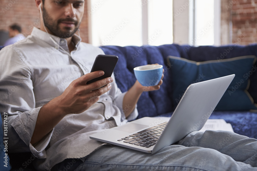 Businessman Working And Drinking Coffee On Sofa In Office Businessman Working And Drinking Coffee On Sofa In Office