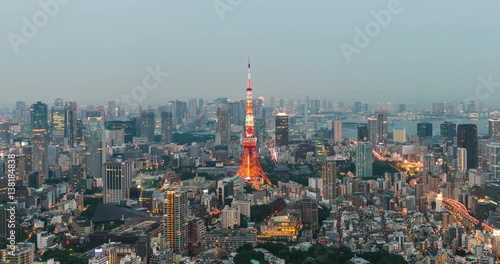 Time-lapse of Skyline with the Tokyo tower at sunset. Tokyo tower is a communications and observation tower located in the Shiba-koen district