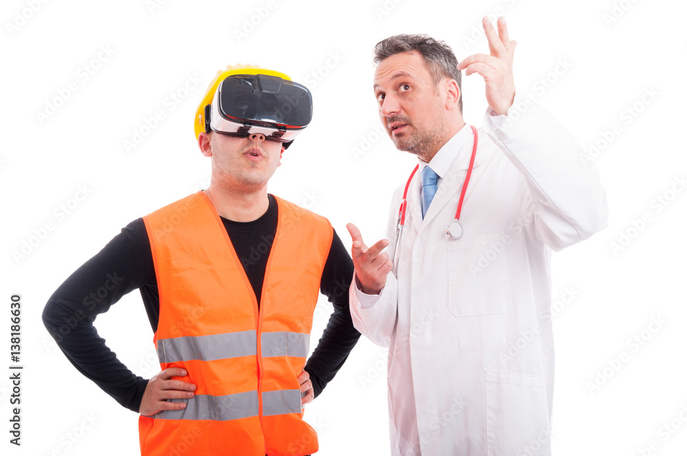 Constructor wearing virtual reality glasses with medic showing something Constructor wearing virtual reality glasses with medic showing something