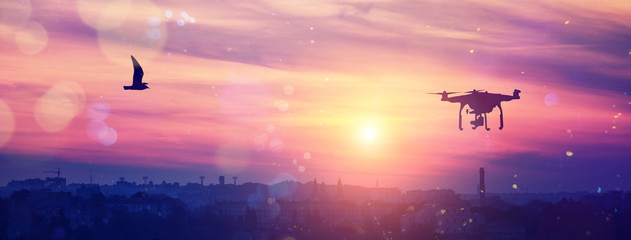 drone in the sky at majestic colorful sunset. over the evening citi. soft light effect, instagram toning effect
