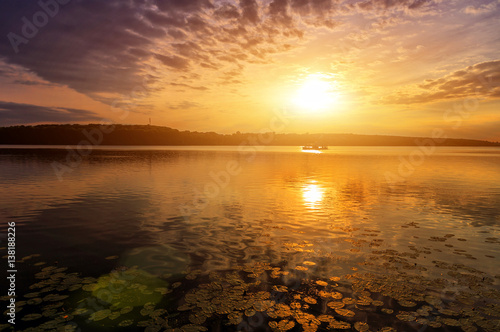 warm sunny sunset at the lake. © jenyateua