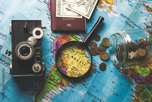Concept of travel. Money, camera, passport, sunglasses on wooden background. accessories for travelling. copy space