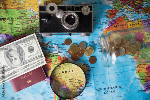 Concept of travel. Money, camera, passport, sunglasses on wooden background. accessories for travelling. copy space
