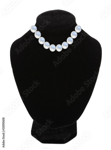 Pearl necklace on black mannequin isolated over white
