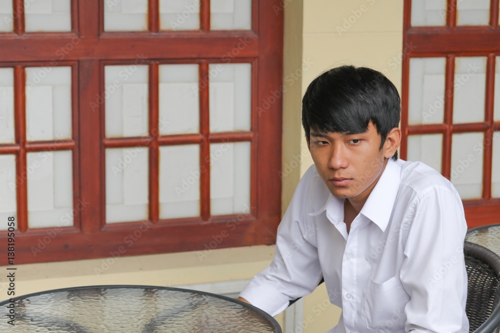 Young man handsome is sitting waiting in coffee shop Young man handsome is sitting waiting in coffee shop