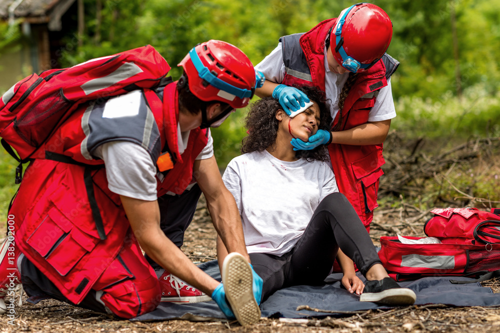 Behang Rescue team helping injured victim