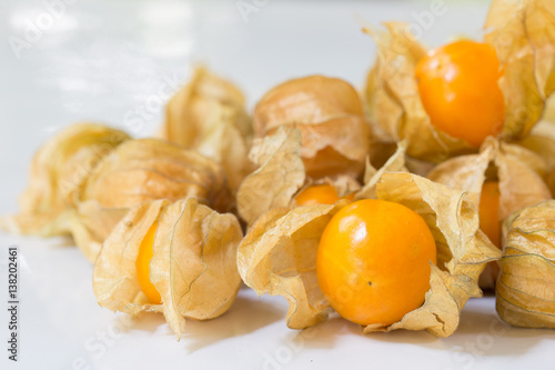 Cape gooseberry nature fruits of tropical on white plate / Blurred and selective focus ..