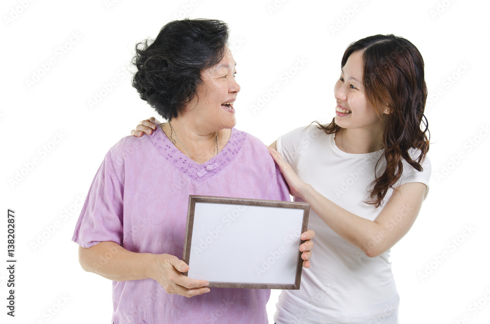 Mother and daughter with blank board Mother and daughter with blank board