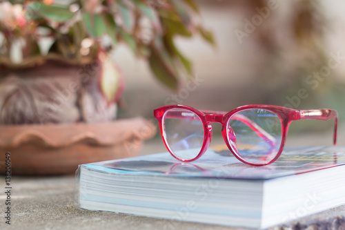  book with red glasses on top 