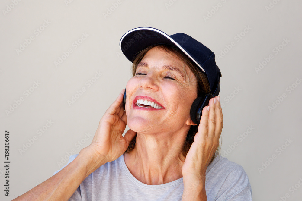 older woman enjoying music on headphones older woman enjoying music on headphones